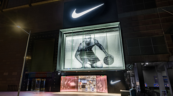 The storefront of a Nike store in China, featuring a giant image of a basketballer.