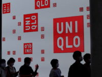 Uniqlo owner trims profit forecast on new Covid-19 curbs