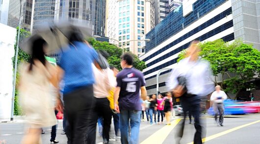 people cross a street in Singapore