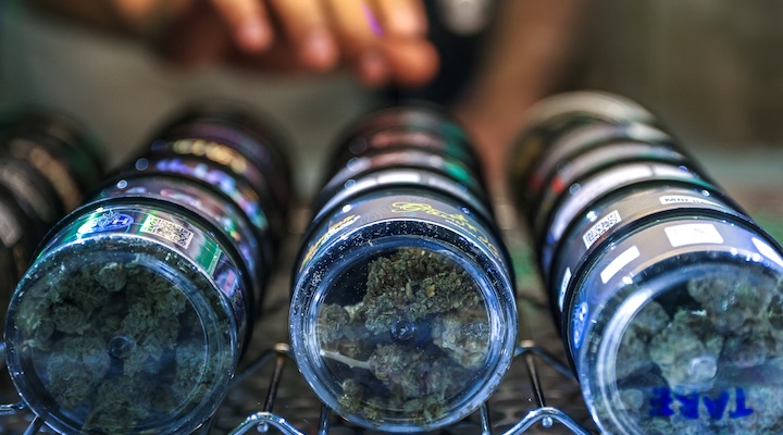 Punnathat Phutthisawong, a staff member at a cannabis shop called "Green House Thailand" arranges cannabis inside his shop on Khaosan Road, Bangkok.