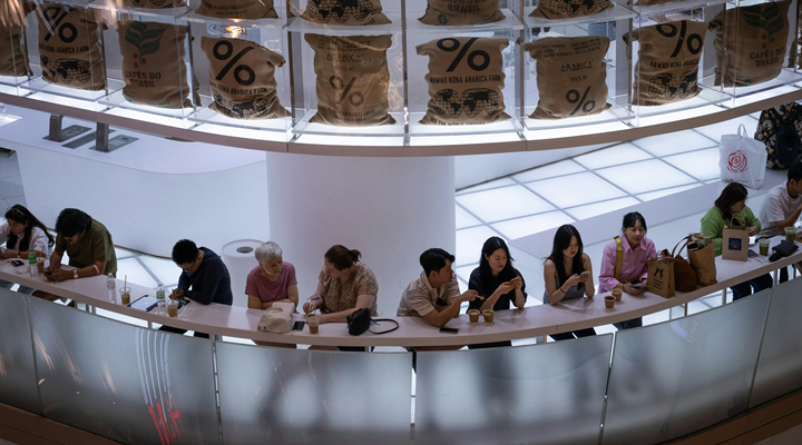 a group of people sitting at a counter in a store