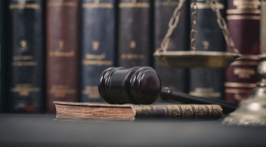 Image of gavel in a library.