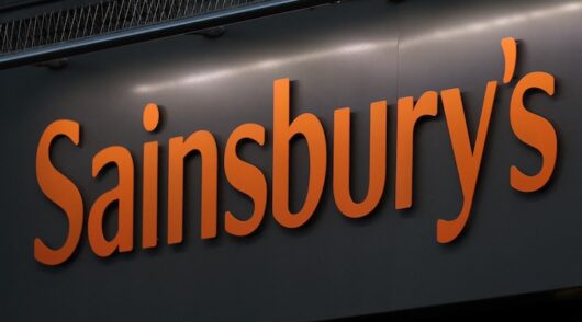 A sign is displayed near a Sainsbury's Local store