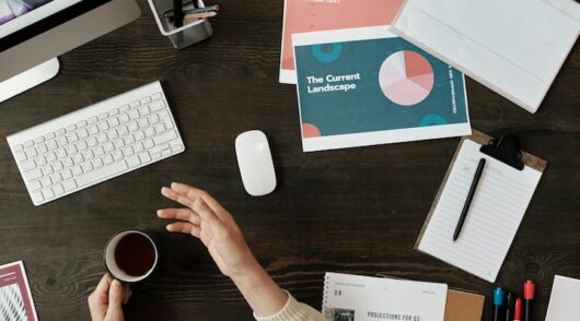 Woman working with computer and notes at desk