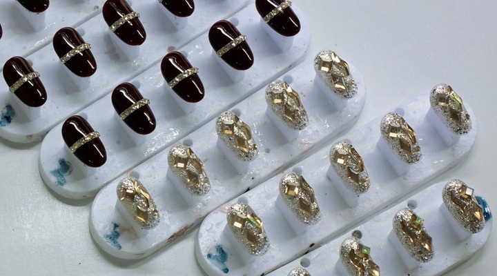 Decorated press-on nails on display.